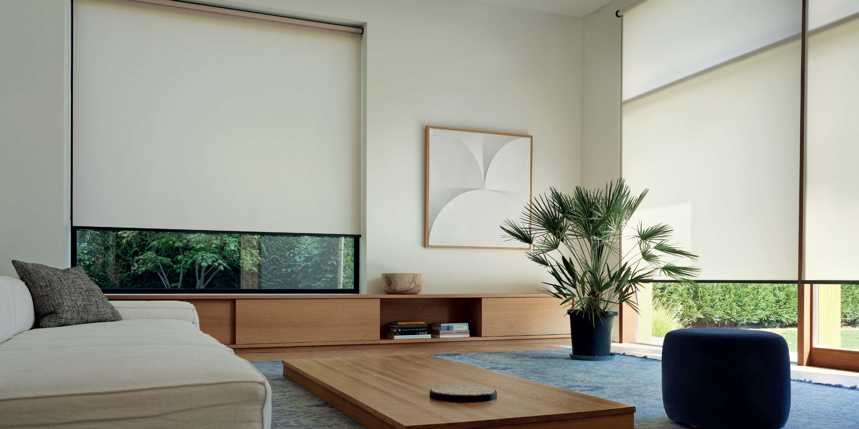 Warm toned home with neutral colors and crestron roller shades