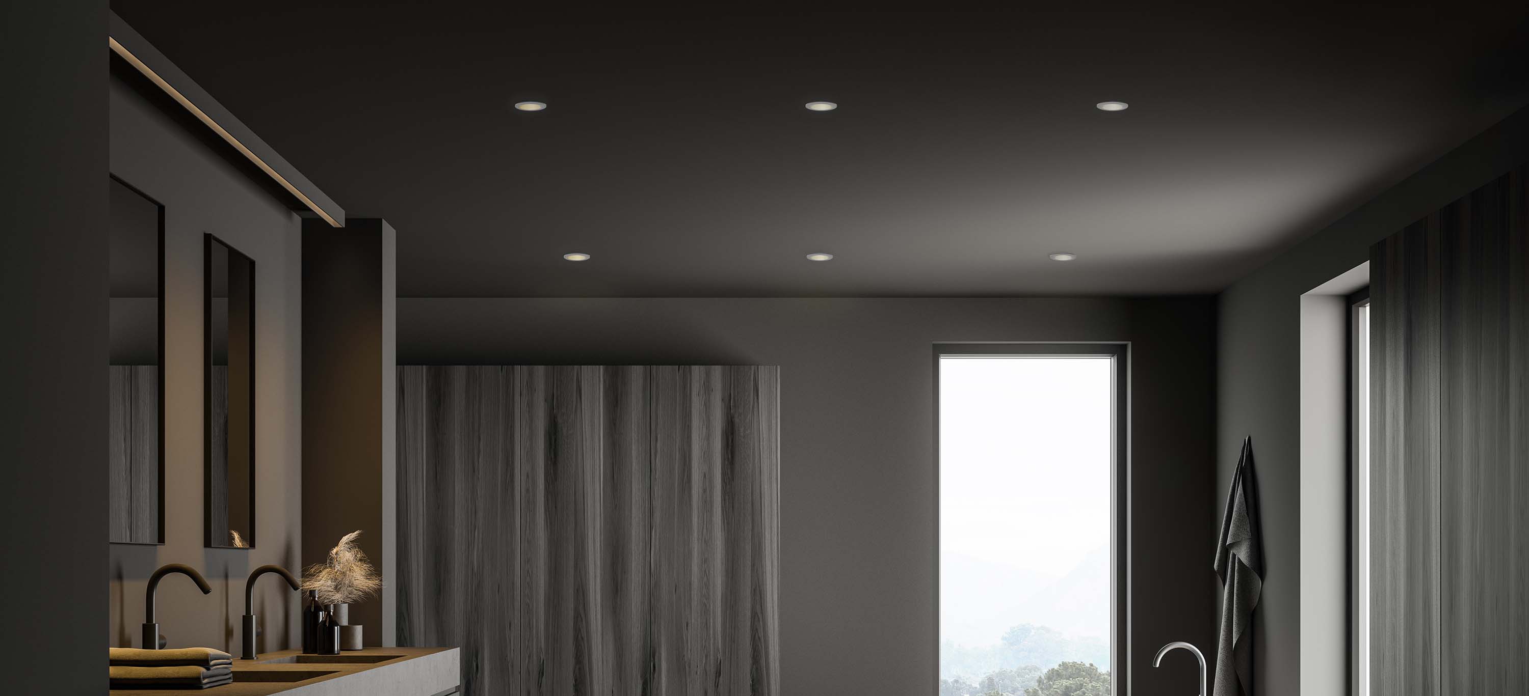 Modern home exterior illuminated with downlights showcasing architectural features and large windows.