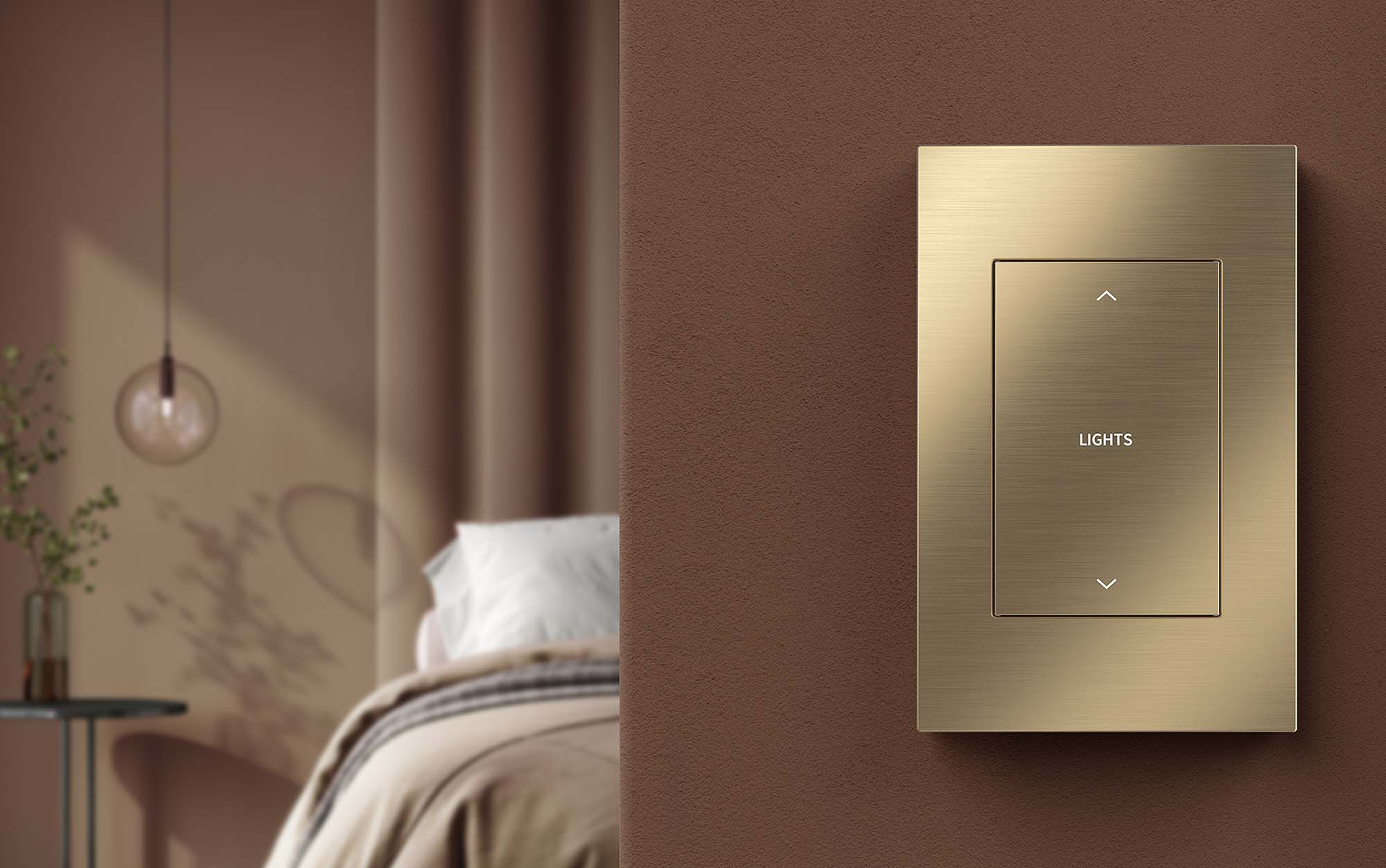 A modern farmhouse style home with picture windows at night with warm lighting inside where a kitchen and dining room are visible though the windows. 